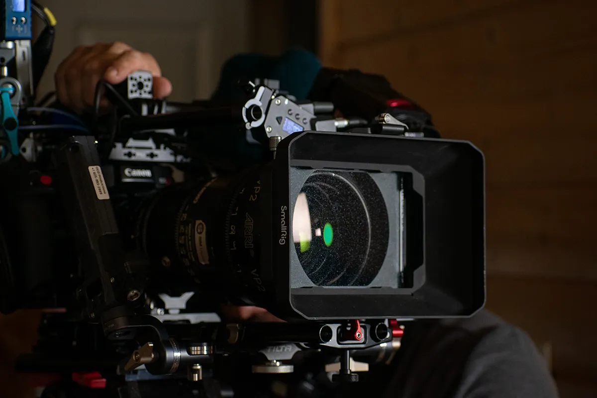 Close-up view of the front of a large movie camera.