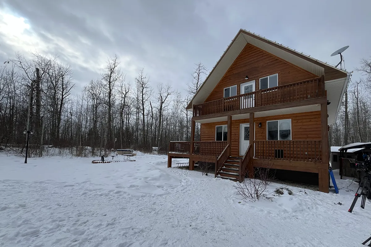 A cabin with snow around it.